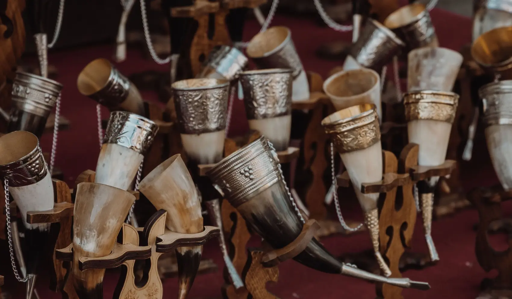 Georgian drinking horns with silver rims displayed on wooden stands